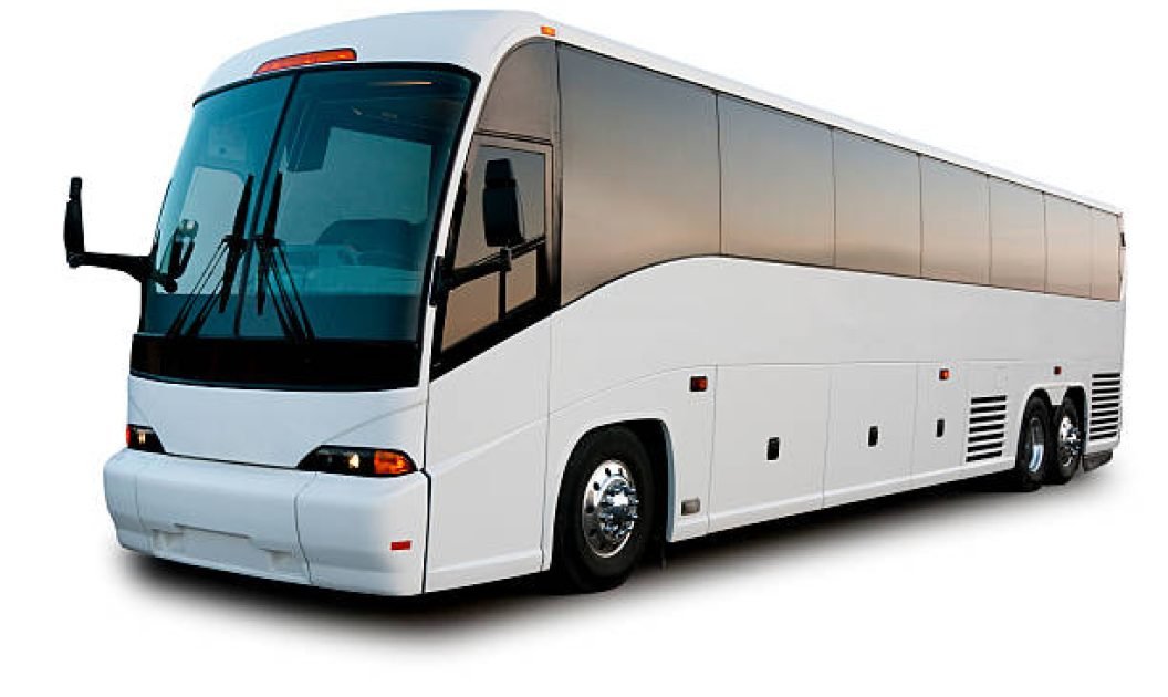 Passenger bus shot at dawn with warm glow reflected in windows. This image is isolated on a white background.